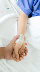 woman patients hand holder by his boy friend