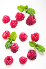 Raspberries and mint on yogurt background