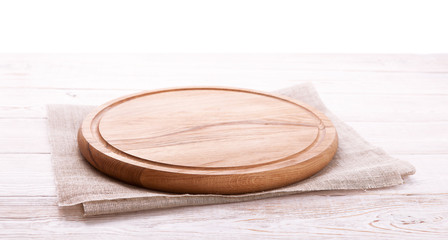 Napkin and board for pizza on wooden desk. Canvas, dish towels on white wooden table background top...