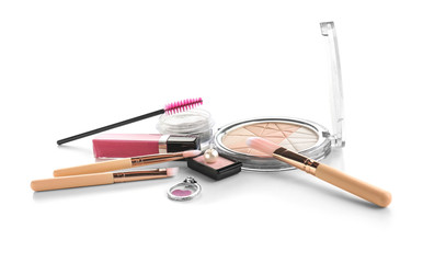 Decorative cosmetics with brushes on white background