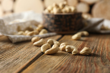 Tasty cashew nuts on wooden table