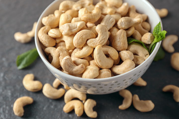 Bowl with tasty cashew nuts on table