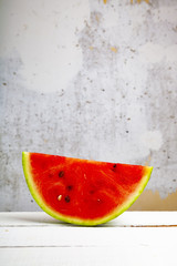 Fototapeta na wymiar Piece of watermelon on a wooden table