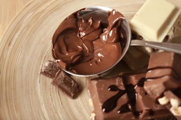 Ladle with molten chocolate on plate