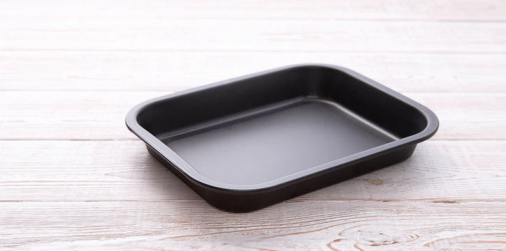 Empty baking tray for pizza close up on white wooden background top view square. Mock up for design
