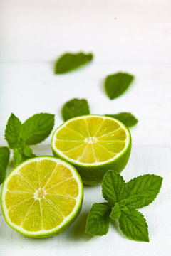 Lime and mint on a  wooden table.
