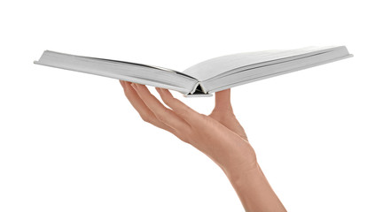 Female hand holding book on white background