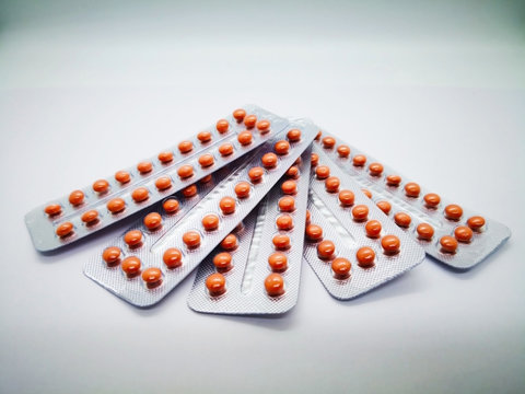 Oral contraceptive drug. 21 brown pills consist of Ethinyl estradiol 0.035 mg. and Cyproterone acetate 2.0 mg. White background, selective focus and copy space.