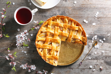 Composition with tasty apple pie on wooden table
