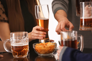 Friends drinking beer in bar