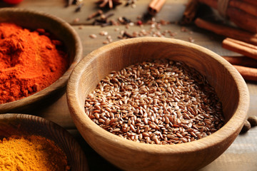 Bowl with flax seeds on wooden table