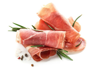 Tasty prosciutto slices with rosemary and spices on white background