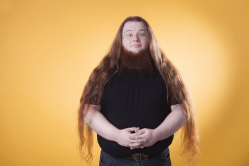 Portrait of a fat man on a yellow background.