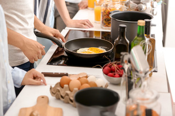Friends cooking together in kitchen