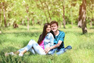 Fototapeta premium Happy young couple resting in green park