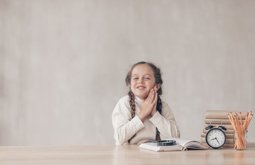 Happy little pupil with a book