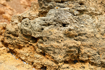 closeup of stone on the beach, sea coast with high hills, beautiful wild landscape