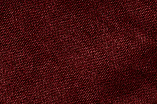 Dark red canvas texture with visible fibers. Textile background