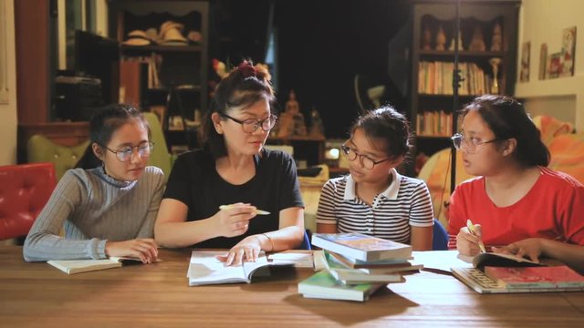asian woman teacher teaching teenager in modern class room