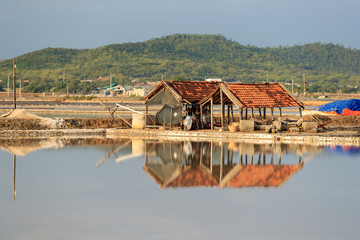 Obraz premium Reflection of the construction on the water of salt field in Vietnam