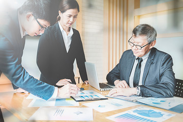 Business concept. Business people discussing the charts and graphs showing the results of their successful teamwork.