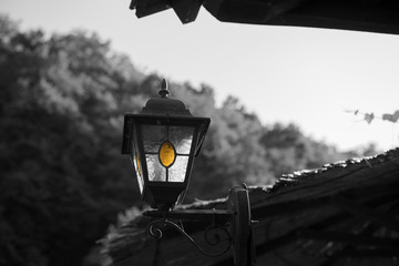 Small old and vintage metal lantern, street lamp. Black and white image.