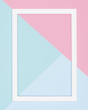 Abstract geometrical pastel blue, teal and pink paper flat lay background. Minimalism, geometry and symmetry template with empty picture frame mock up.