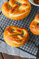 Traditional salted pretzels with oregano over blue stone background. Oktoberfest or beer snack concept.