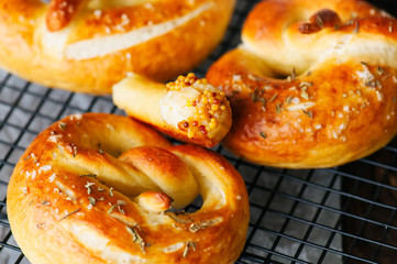 Traditional salted pretzels with oregano over blue stone background. Oktoberfest or beer snack concept.