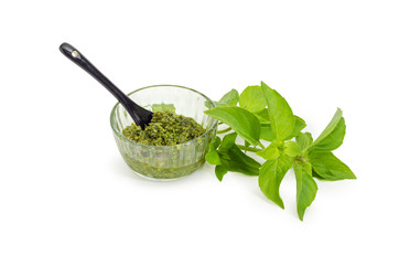 Pesto in the small glass bowl and basil twig