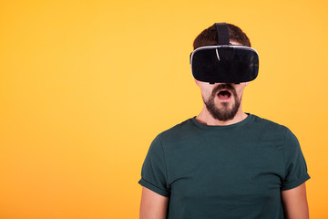 VR virtual reality headset on amazed man head who is trying it for the first time. Innovative goggles gadget