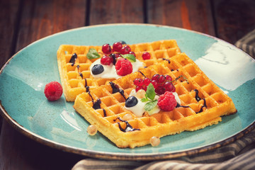 Homemade waffles with berry fruit,mint and chocolate sauce