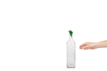 Empty transparent glass oil dispenser with hand isolated on white background, copy space template