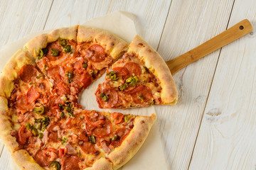 Pizza on a white woodwn table