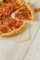 Pizza on a white woodwn table