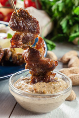Traditional pork satay with peanut sauce and vegetables