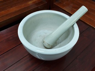 White ceramic mortar, Put on a wooden table