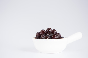 black pearls. Boiled tapioca pearls for bubble tea on white background. Copy space