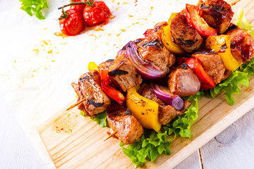 tasty and colorful meat skewers with peppers and onions