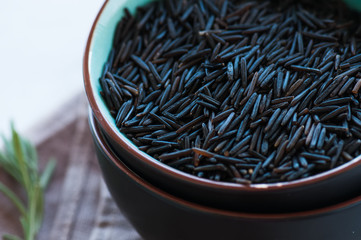 Close up of raw wild rice in a bowl. Toned.