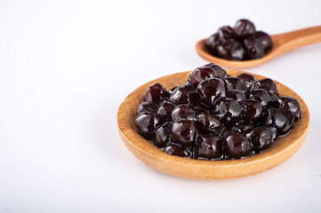 black pearls. Boiled tapioca pearls for bubble tea on white background. Copy space