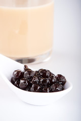 black pearls. Boiled tapioca pearls for bubble tea on white background. Copy space