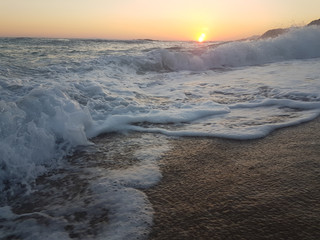 sunset sea waves foam splash  in summer Preveza Vrahos Greece
