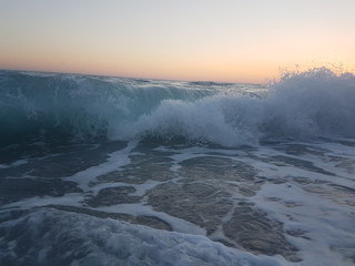 sunset sea waves foam splash  in summer Preveza Vrahos Greece