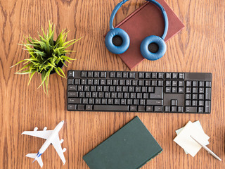 Traveler concept image of businessman desktop view,headphones ,notes,books