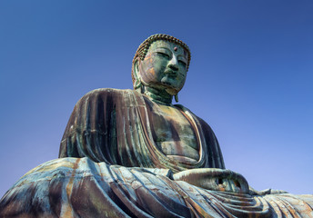 Great Buddha bronze statue under a blue sky, Kamakura Japan
