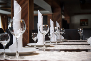 Empty wine glasses and napkins on the banquet table.Serving banquet table in a restaurant.