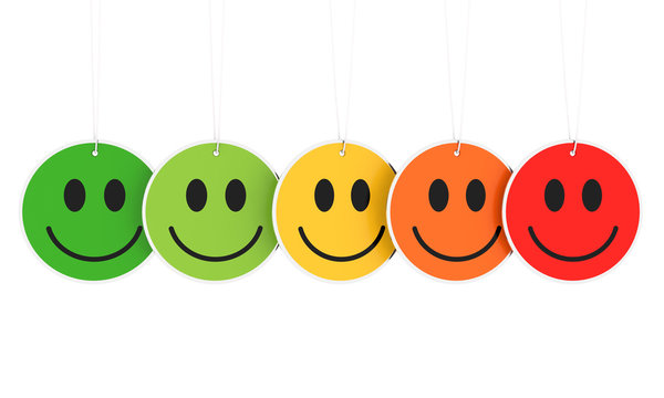 Colored smiley faces hanging on white background 