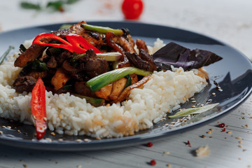 Fried meat with rice in a plate