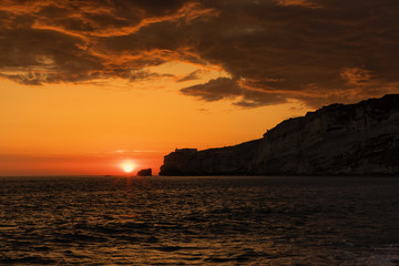 Fototapeta na wymiar Sunset over the lighthouse of Nazare, Portugal